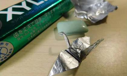 Small crane by folding origami with a gum wrapper.