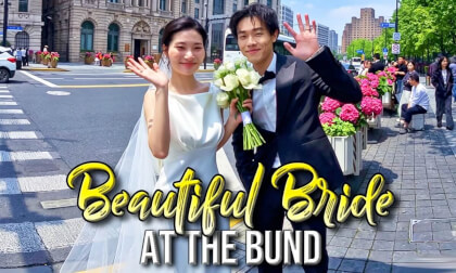 Happy couples taking wedding photos on the Bund.