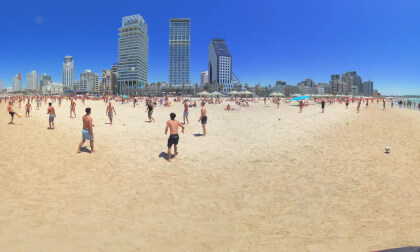 Walking Through Tel Aviv's Friday Beach Vibe: Sun, Matkot & Footvolley Strolling under a cloudless blue sky, the warm sand comes alive with sunbathers, the iconic clack of Matkot paddles, and Footvolley circles, creating the ultimate blend of weekend joy