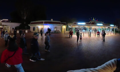 15.1 Walking under. Disneyland's entrance sign 'Here you Leave Today and enter the World of Yesterday, Tomorrow, and Fantasy (at night)