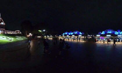 23.3 Walking (solo) out front of Disneyland revealing the train station and Mickey Mouse flowers and 70th anniversary sign at night