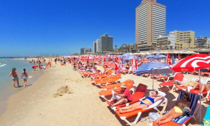 Walking Through Tel Aviv's Friday Beach Vibe: Sun, Matkot & Footvolley Strolling under a cloudless blue sky, the warm sand comes alive with sunbathers, the iconic clack of Matkot paddles, and Footvolley circles, creating the ultimate blend of weekend joy