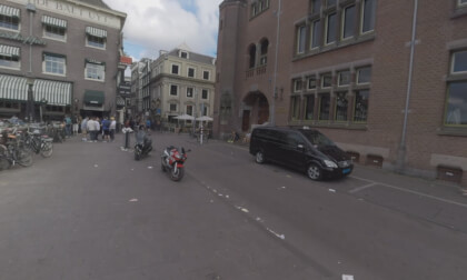 360 VR Small dirty street with walking people and view to the canal, Amsterdam