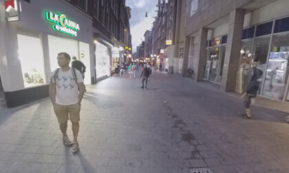 360 VR People walking in city alleys with stores in the evening