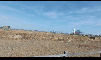 Walking along Landguard nature reserve looking towards Felixstowe Docks