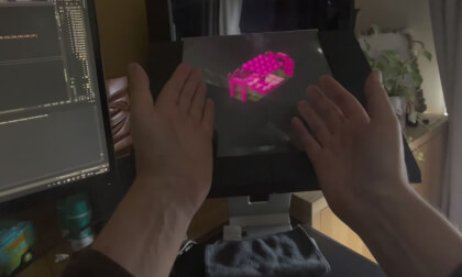 Spatial Video of Holographic Display showing Alien 8 remake - bracketed by hands to show aerial spatial image