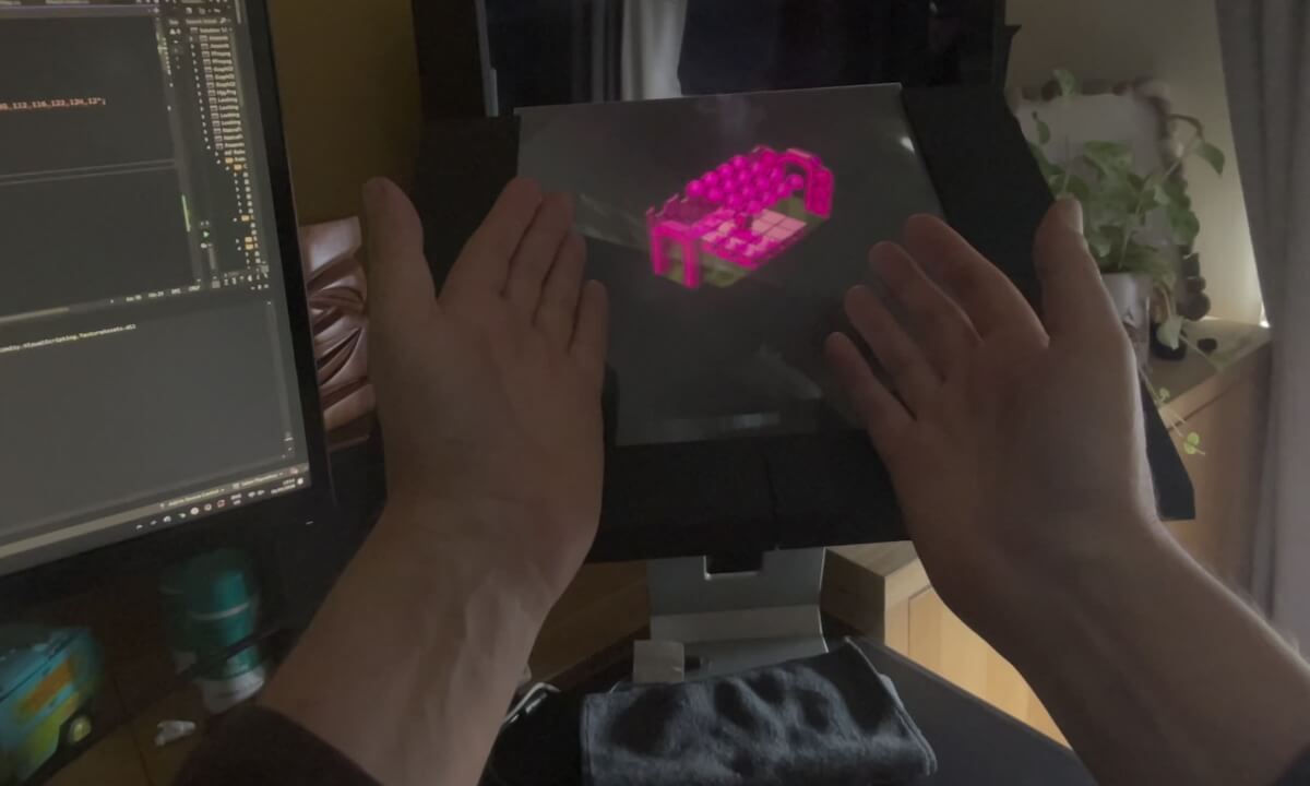 Spatial Video of Holographic Display showing Alien 8 remake - bracketed by hands to show aerial spatial image
