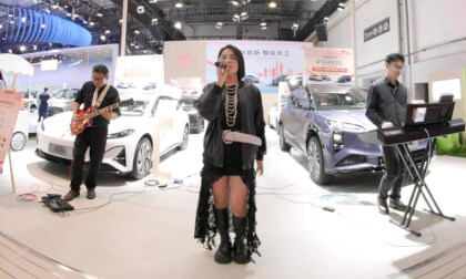 A singer and band perform at the Qingdao Auto Show