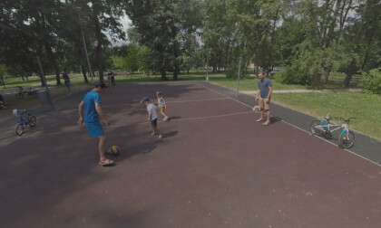 360 VR Fathers and children playing football on sports ground in the park 360 VR Fathers and children playing football on sports ground in the park