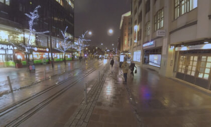 VR Night view of Helsinki street with walking people and tram traffic, Finlandd