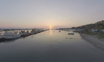 360 VR Resort town scene with beach and harbour at sunset, Greece
