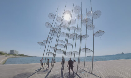 360 VR Seafront with tourists exploring Umbrellas sculpture, Thessaloniki