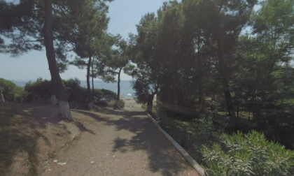 360 VR People walking along parkway leading from cottage to the beach, Greece