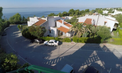 360 VR Trikorfo Beach resort with villas and car traffic on road, Greece 360 VR Trikorfo Beach resort with villas and car traffic on road, Greece