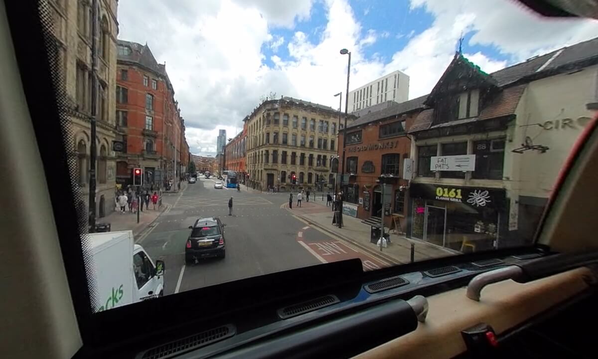A double-decker bus ride through Manchester city centre, England.