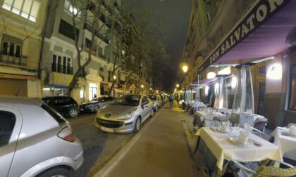 360 VR Street with cars and outdoor cafe in night Valencia, Spain