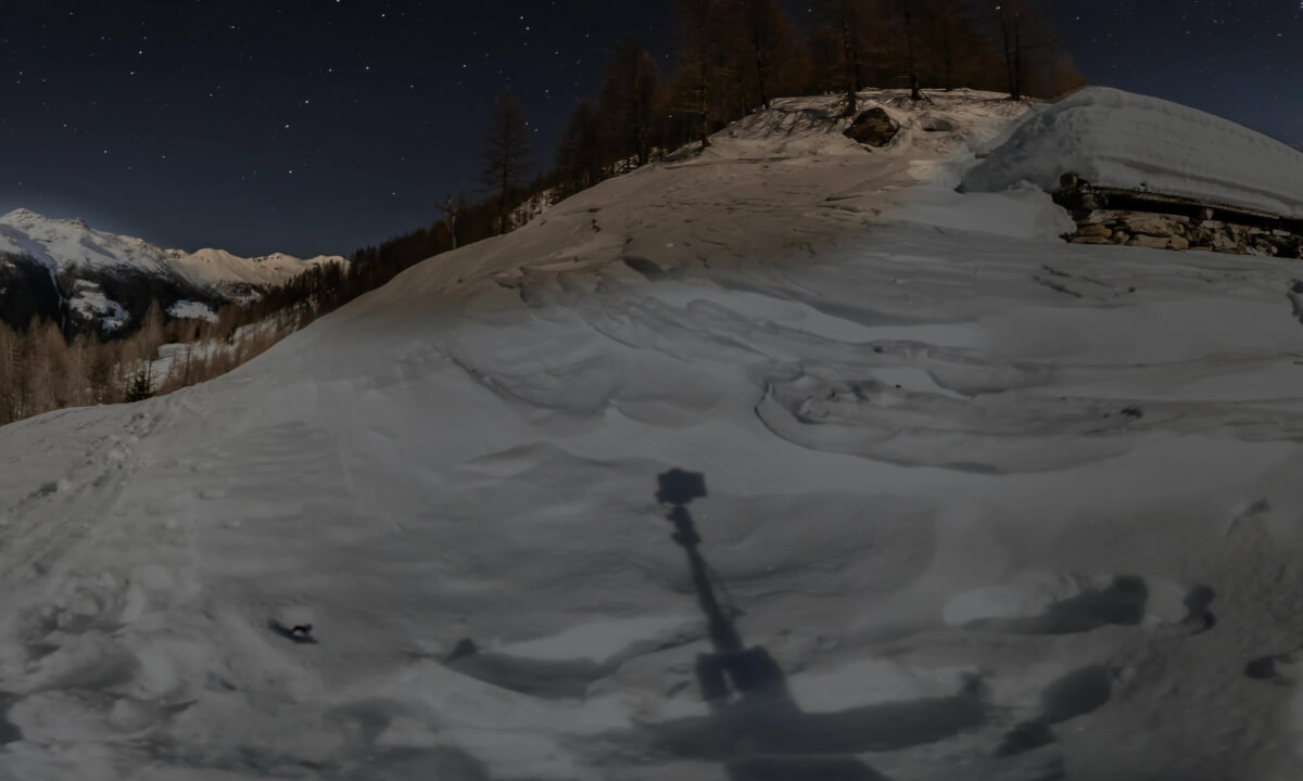 Nighttime timelapse outside a snowy bivouac in the middle of the Italian Alps. From night to day.