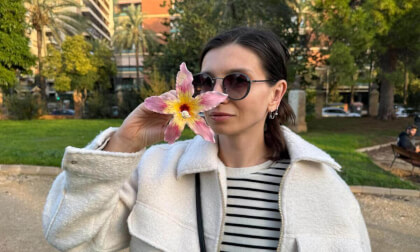 Yana playing with a flower from Drunken Stick tree at Jardin del Real, Valencia