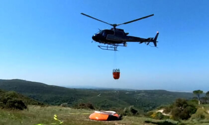 Breaking news: Mount Carmel, Israel—A police helicopter fills its bucket with water and flies to extinguish a forest fire. Drill. Breaking news: Mount Carmel, Israel—A police helicopter fills its bucket with water and flies to extinguish a forest fire. Drill.
