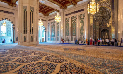 A preyer at Sultan Qaboos Grand Mosque in Mascate, Oman A preyer at Sultan Qaboos Grand Mosque in Mascate, Oman