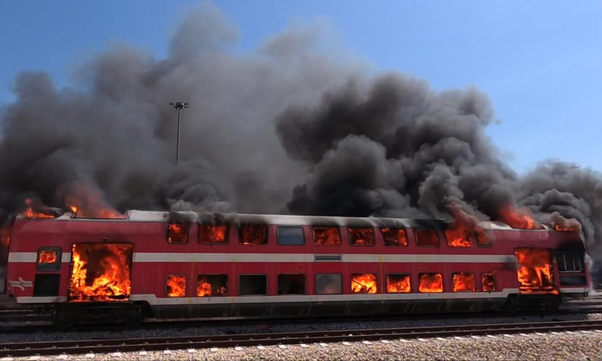 A train car caught fire. Firefighters arrived swiftly on the scene and extinguished the blaze using high-pressure water hoses. Just a drill.