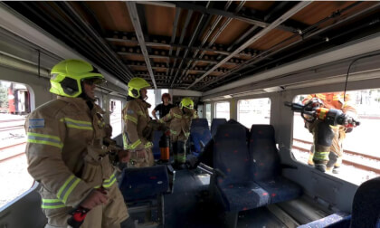 Firefighters use cutter to free trapped dolls in Haifa train drill.