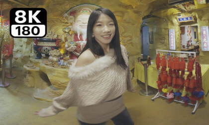 The young lady dances before the God of Wealth.