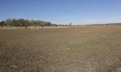 An Empty Field with Shelters in the Background (V_F106_S010)