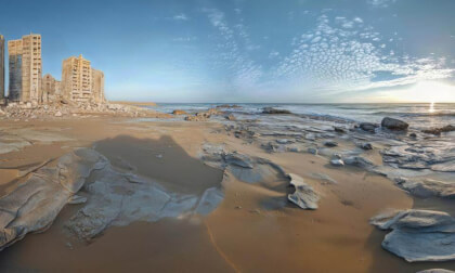 Beach At Sunset Next To Post Apocalyptic Destroyed City