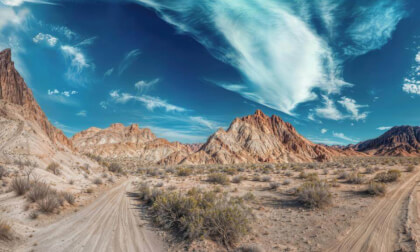 Desert Path Leading Through Valley In Barren Environment