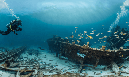Underwater Diver Exploring A Wrecked Ship