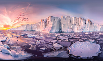 Iceberg Surrounded By Sea Ice In Arctic At Sunset