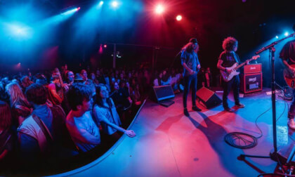 Rock Concert With Electric Guitars And Drums In Small Venue